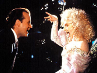 Carol Kane (right) is one of three ghosts to visit Bill Murray in <i>Scrooged</i>. Image