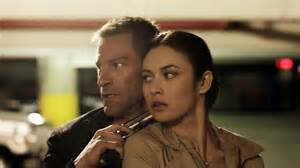 Aaron Eckhart and Olga Kurylenko are old friends who meet again in 'Erased'